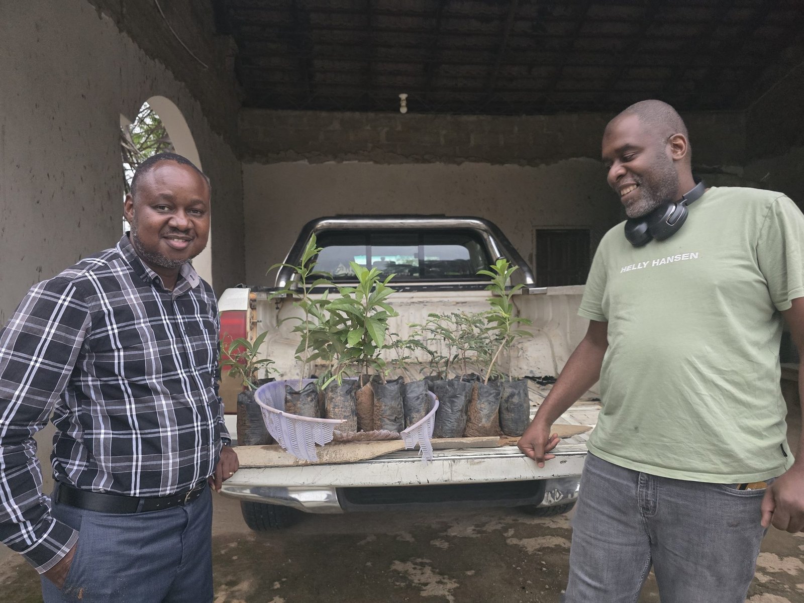 Team members with seedlings loaded on pickup