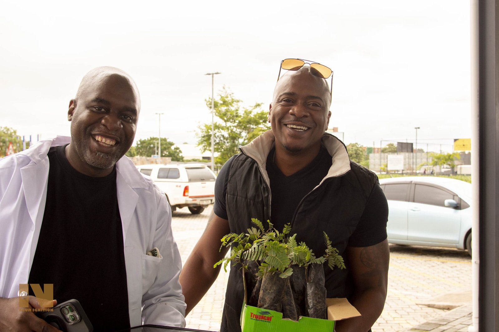 Recipient collects seedling from DIF team member