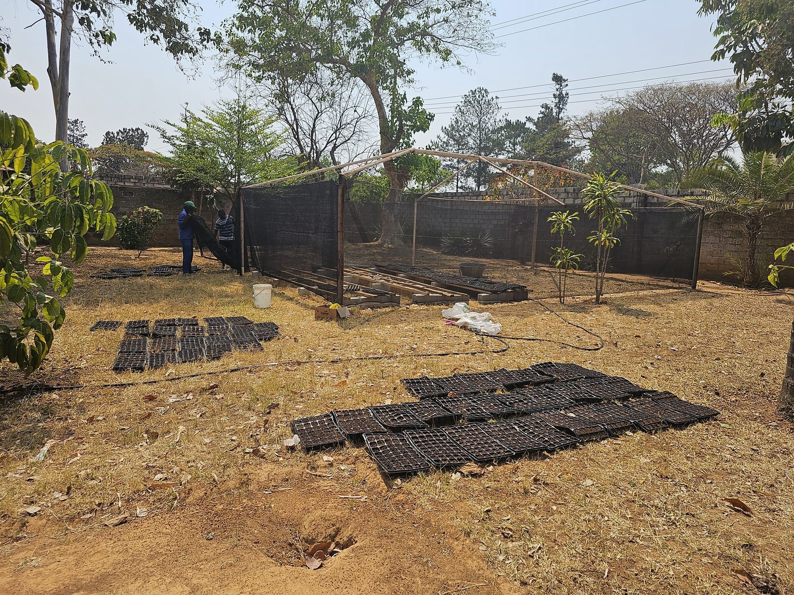 Shade netting being stretched over the frame